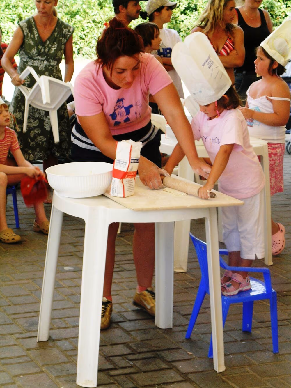 Kinderen knutselen aan tafel tijdens een creatieve workshop van de mini club op Camping Bella Italia