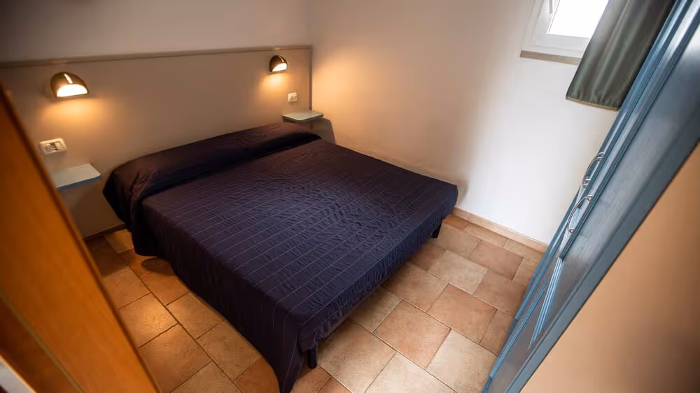 Tweepersoonsslaapkamer in een verblijf van Camping Bella Italia